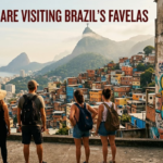 Group of five backpacked tourists overlook a colorful favela hillside in Rio de Janeiro as a mural with 'Cultura Resistencia Comunidad' dominates the wall.