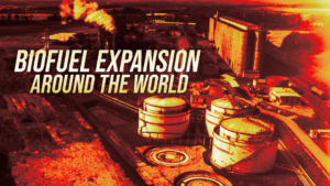 Industrial facility with storage tanks and smokestacks, overlaid by the headline 'Biofuel Expansion Around the World' in bold lettering.