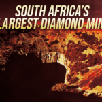 Banner stating "South Africa's Largest Diamond Mine" over a fiery orange canyon landscape.
